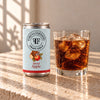 Foreva Farmers Spiced Apple Cola 150ml can with an iced drink on a sunlit stone table
