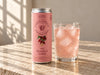 Foreva Farmers Wild Rosehip & Lemon 250ml soda can beside an iced pink drink on a sunlit stone table
